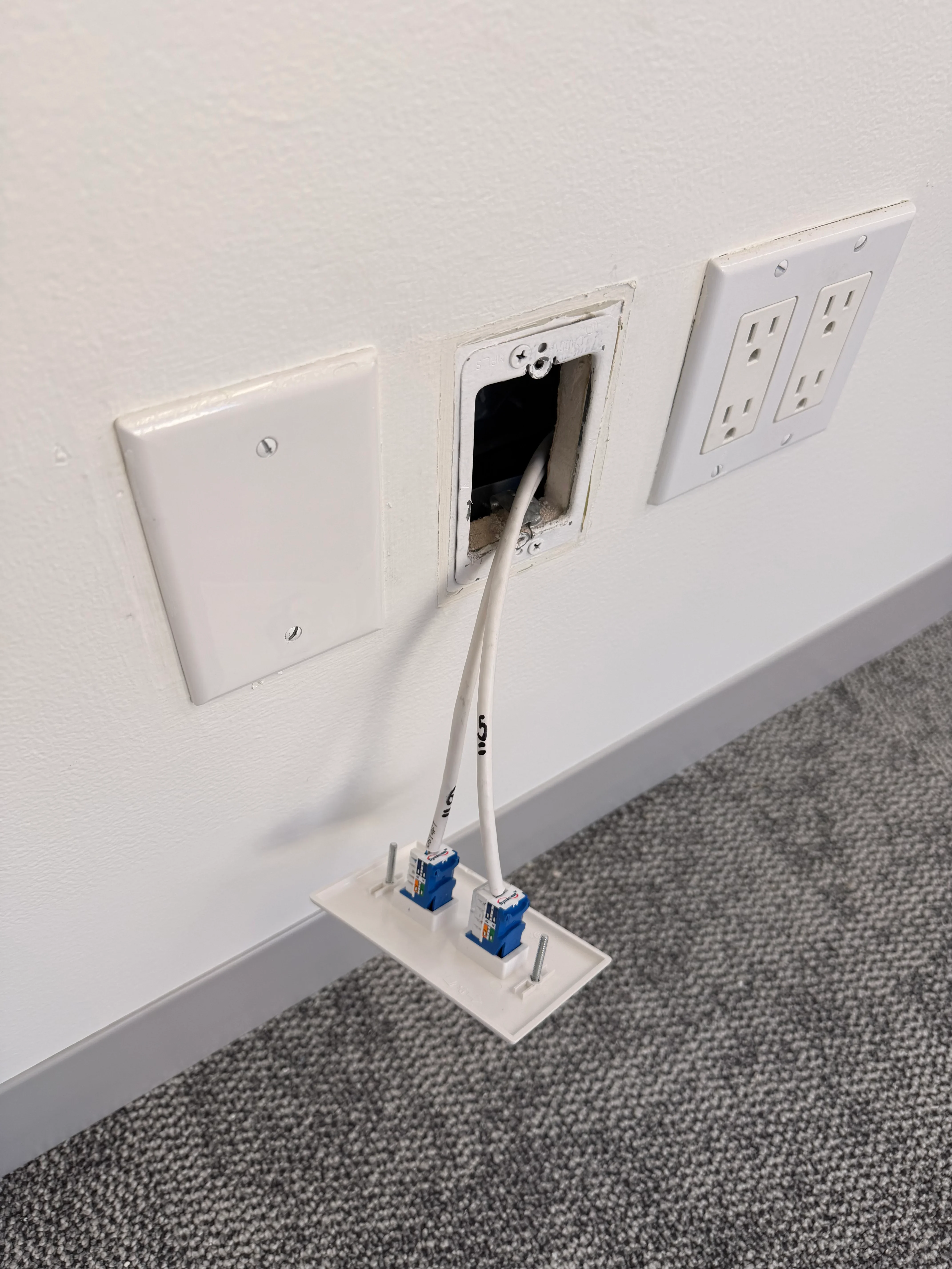 Wall-mounted electrical outlets and network cable installation in commercial space